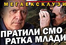 Слика са два човека, један са фотоапаратом, у војној униформи.