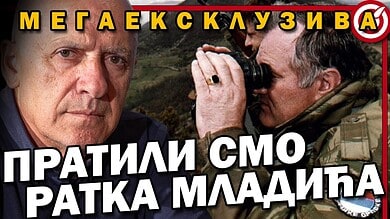 Слика са два човека, један са фотоапаратом, у војној униформи.